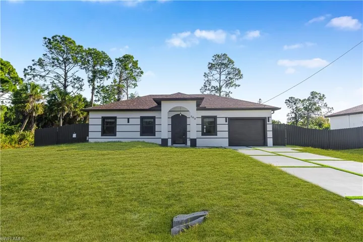 View of front of home featuring concrete driveway, an attached garage, stucco siding, and roof with shingles