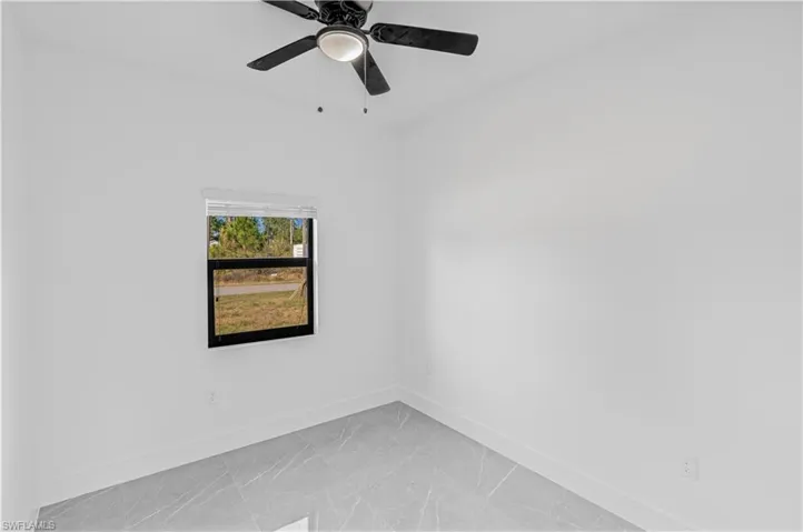 Unfurnished room featuring baseboards