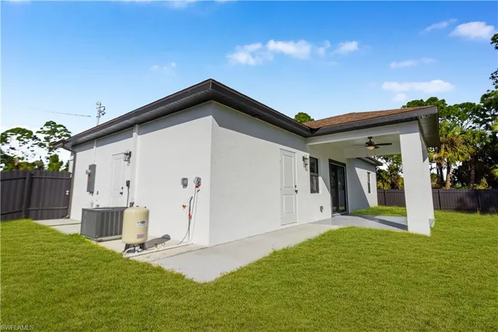 Back of property featuring a ceiling fan and stucco siding