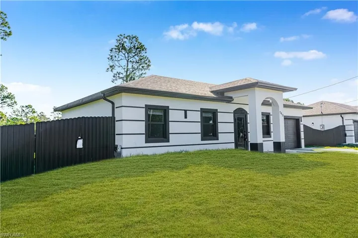 View of front of house featuring an attached garage, stucco siding, and a shingled roof
