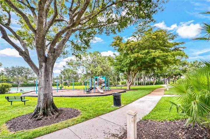 Surrounding community with a playground and a yard