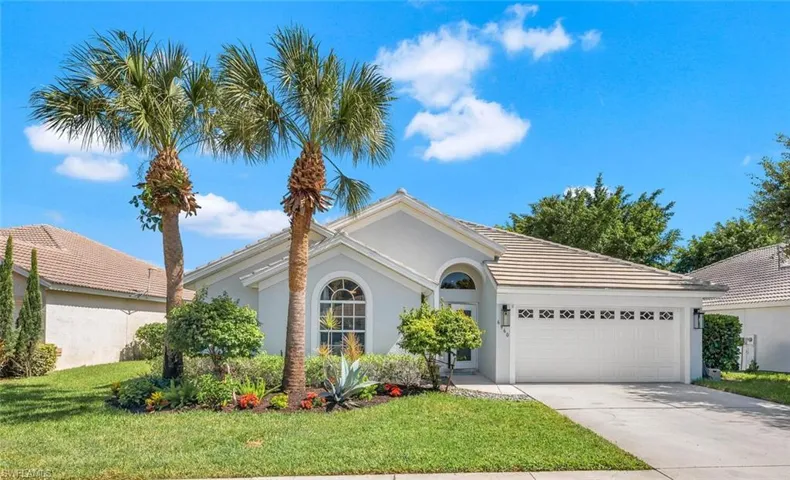 View of front of home featuring a front yard and a garage
