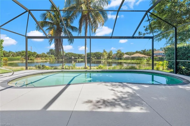 View of swimming pool featuring a lanai and a patio