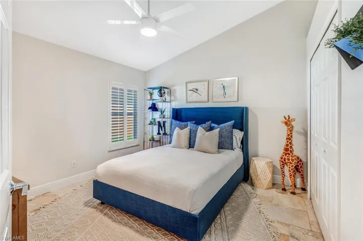 Bedroom with ceiling fan, a closet, and vaulted ceiling