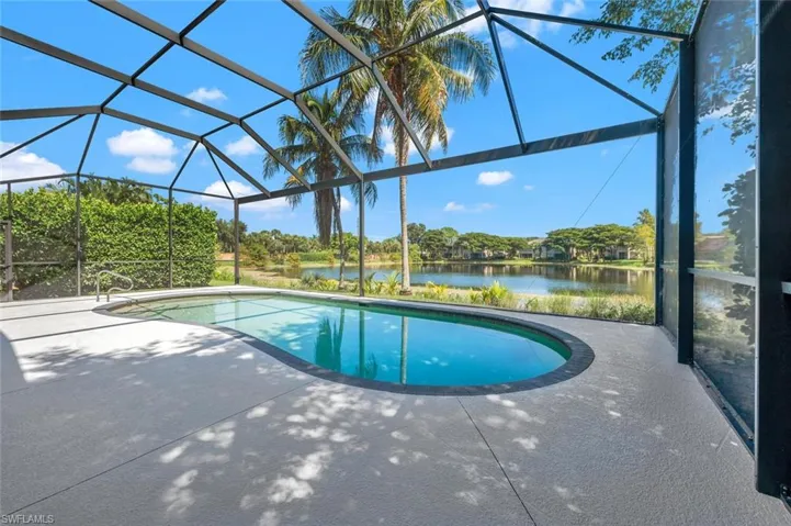 View of pool with a patio and a lanai