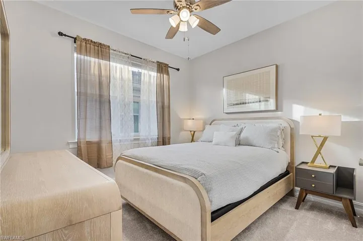 Carpeted bedroom with ceiling fan