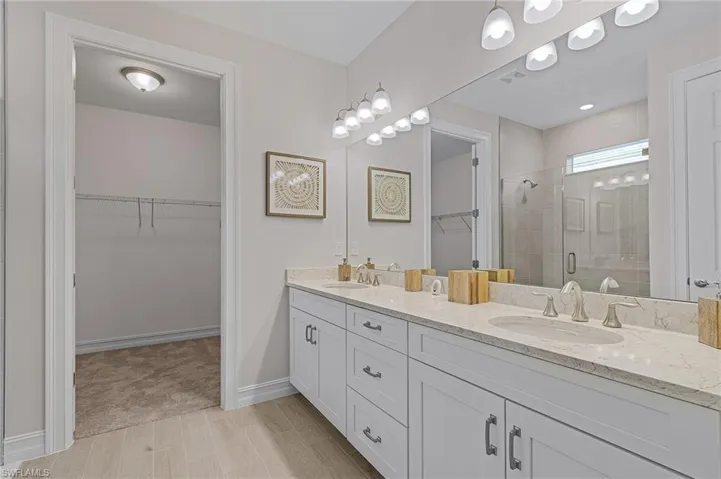 Bathroom featuring vanity, an enclosed shower, and hardwood / wood-style flooring