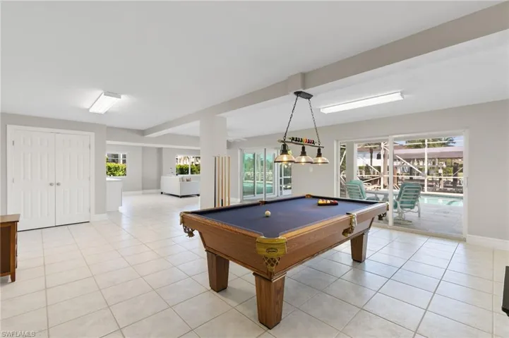Playroom featuring light tile patterned floors, plenty of natural light, and billiards table