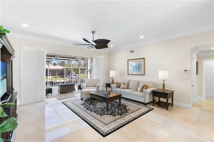 Living area featuring ornamental molding, recessed lighting, a ceiling fan, and a sunroom