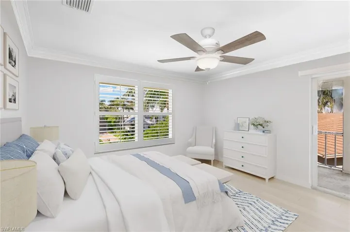 Virtually Staged - Bedroom with wood finished floors, ornamental molding, a ceiling fan, and access to exterior