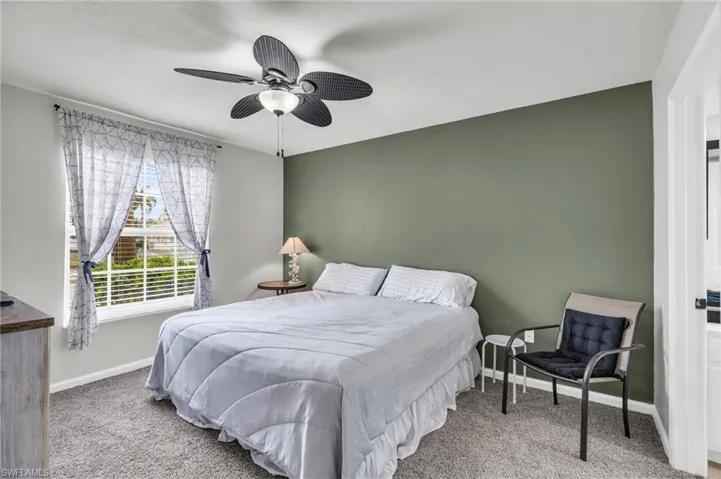 Bedroom with ceiling fan and carpet flooring
