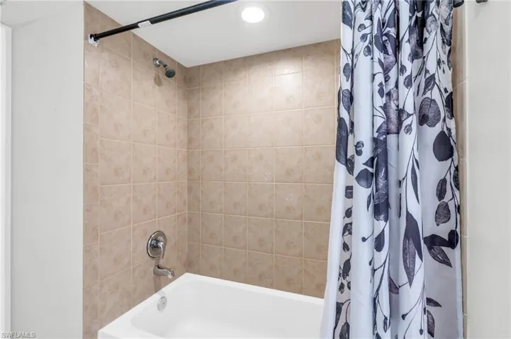 Bathroom with shower / tub combo with curtain