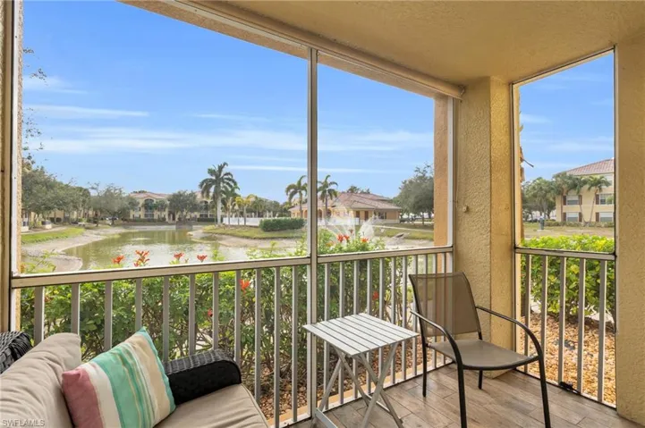 Sunroom / solarium featuring a water view