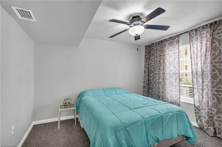 Bedroom featuring ceiling fan and carpet flooring