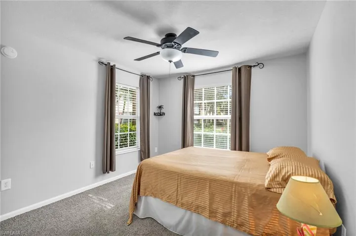 Bedroom featuring ceiling fan and carpet floors