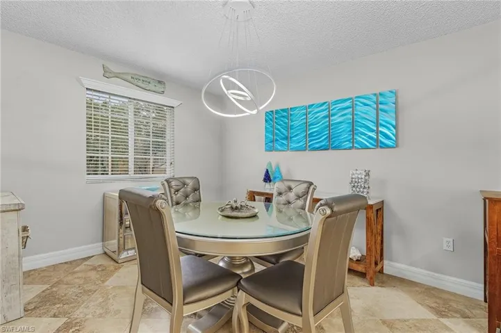 Dining room featuring a textured ceiling and a chandelier