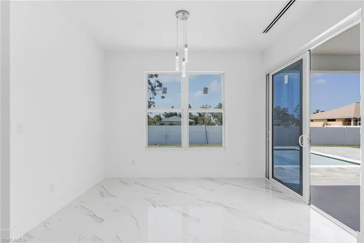 Unfurnished dining area with visible vents, baseboards, and marble finish floor