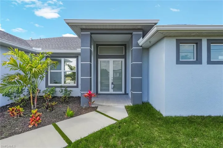 Property entrance with french doors and stucco siding