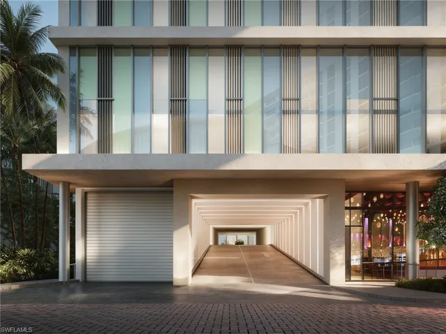 Modern facade featuring glass-curtain walls with vertical paneling, integrated ramped parking structure, and recessed linear architectural lighting. Developer Rendering