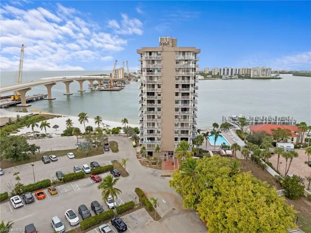View of apartment building / complex featuring a water view and a city view