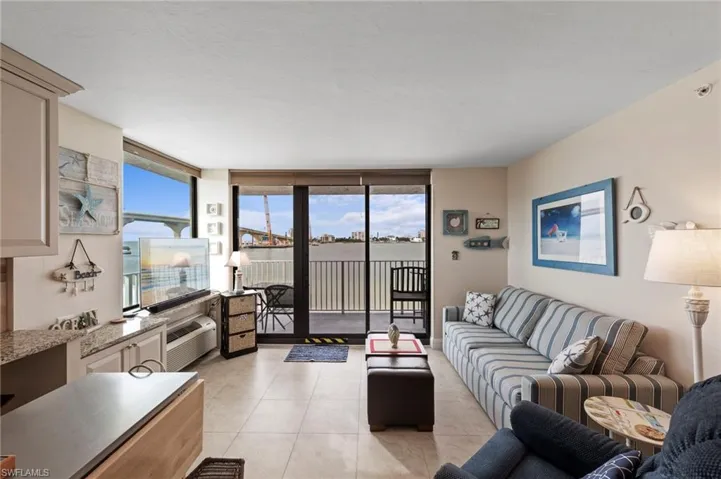 Living area featuring floor to ceiling windows and light tile patterned floors