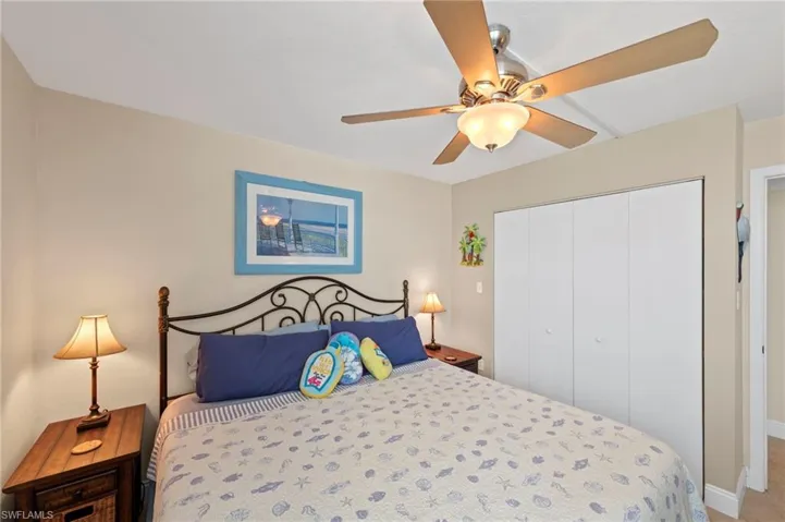Bedroom with ceiling fan and a closet