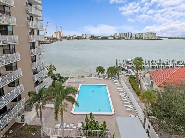 Community pool featuring a view of city and a water view