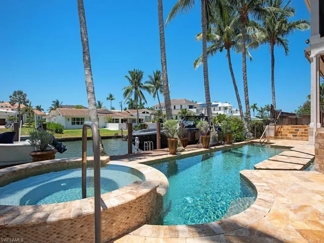 View of pool featuring a patio area and an in ground hot tub