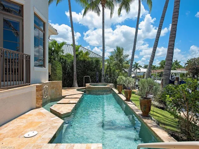 View of pool with an in ground hot tub