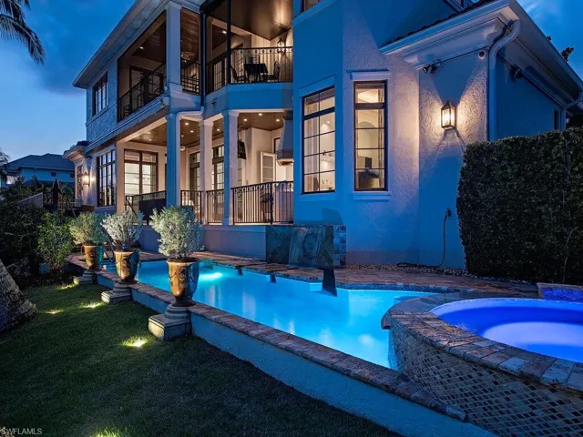 View of swimming pool with a yard and an in ground hot tub