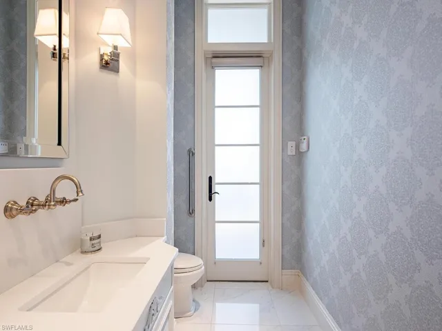 Bathroom with tile flooring, vanity, and toilet