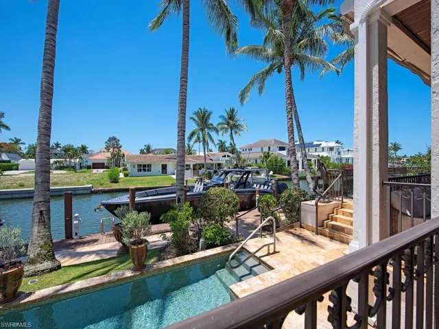 View of swimming pool with a dock and a water view