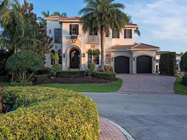 Mediterranean / spanish-style house featuring a garage and a balcony