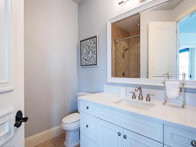 Bathroom featuring toilet, tile floors, and large vanity