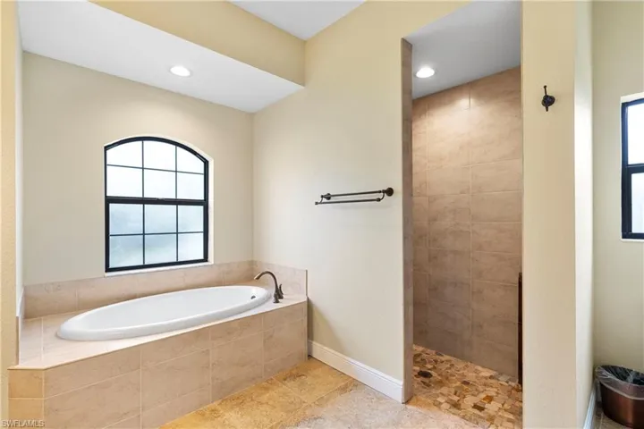 Bathroom ensuite featuring tile shower and bath