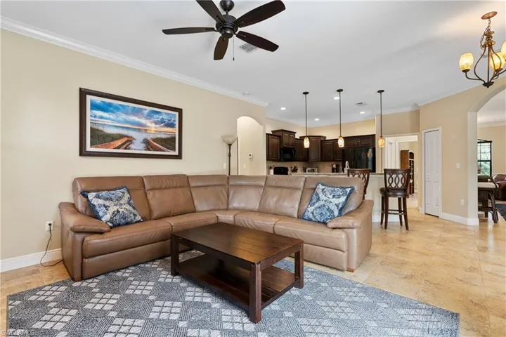 Family room featuring ornamental molding and ceiling fan