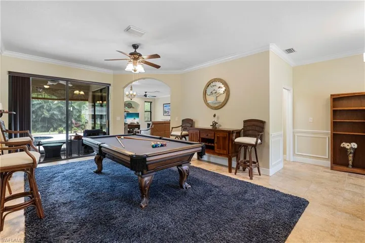 Living room featuring crown molding included in sale