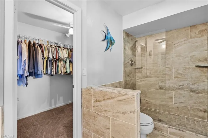 Bathroom with toilet and a tile shower