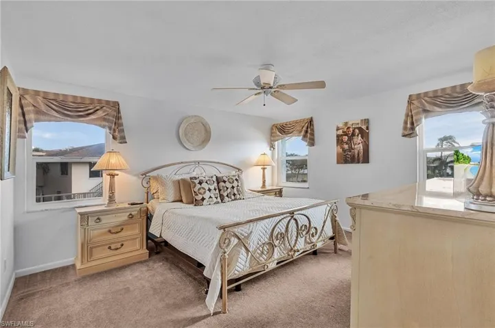 Bedroom with light carpet and ceiling fan