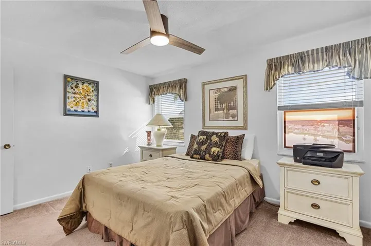 Carpeted bedroom with ceiling fan