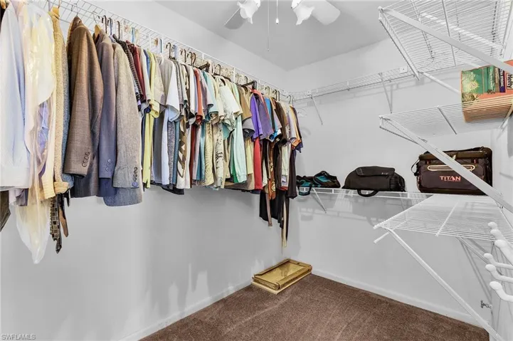 Walk in closet featuring carpet flooring
