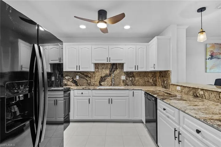 Kitchen with white cabinets, sink, decorative backsplash, light tile patterned floors, and black appliances