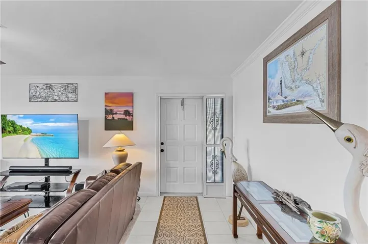 Tiled entrance foyer with ornamental molding
