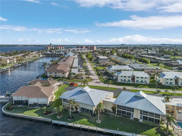 Birds eye view of property with a water view