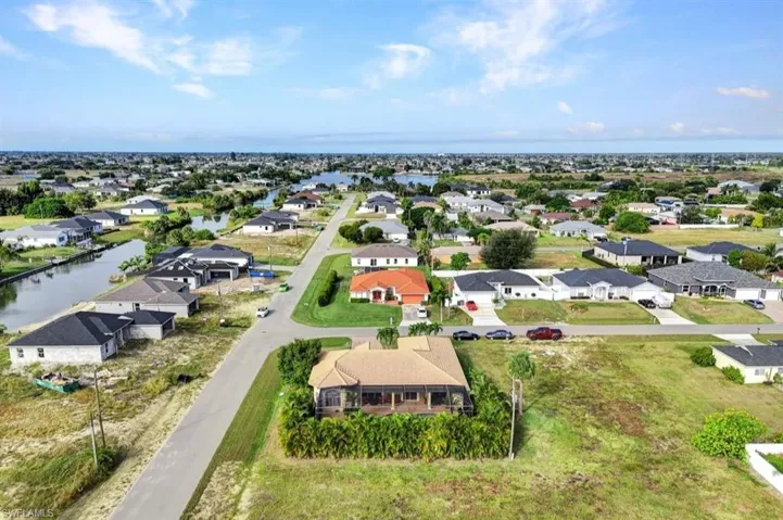 Aerial perspective of suburban area featuring a large body of water