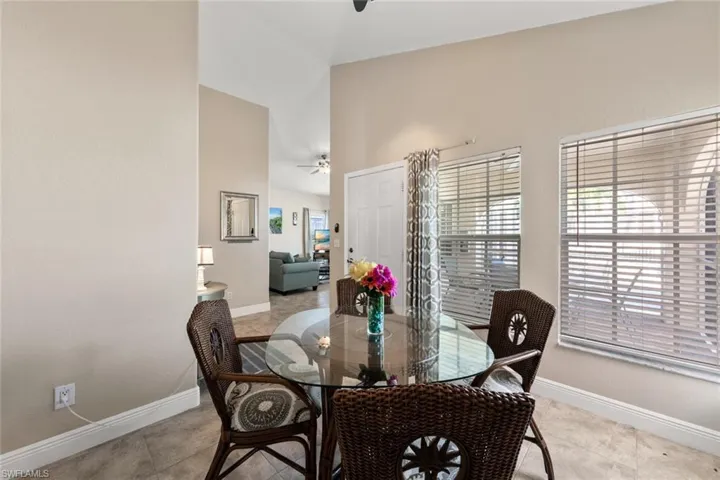 Dining space featuring light tile patterned floors, baseboards, and ceiling fan
