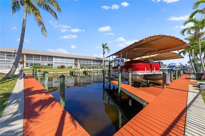 View of dock with a water view and boat lift