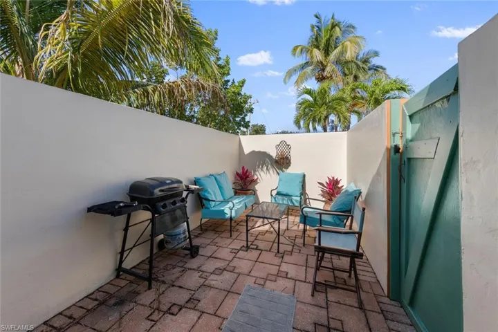 View of patio / terrace featuring fence and a grill
