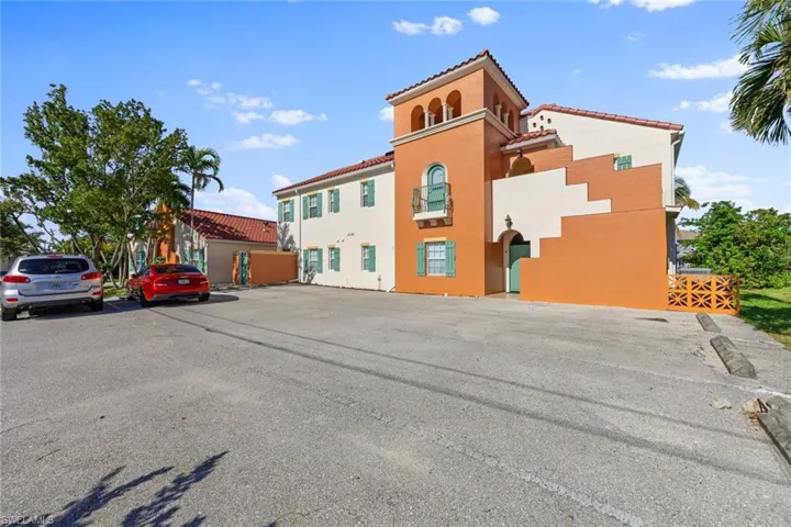 View of property with uncovered parking
