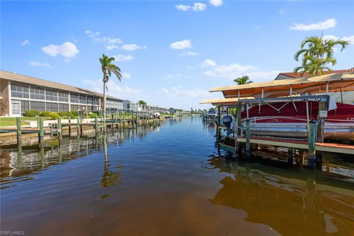 Dock area featuring a water view and boat lift